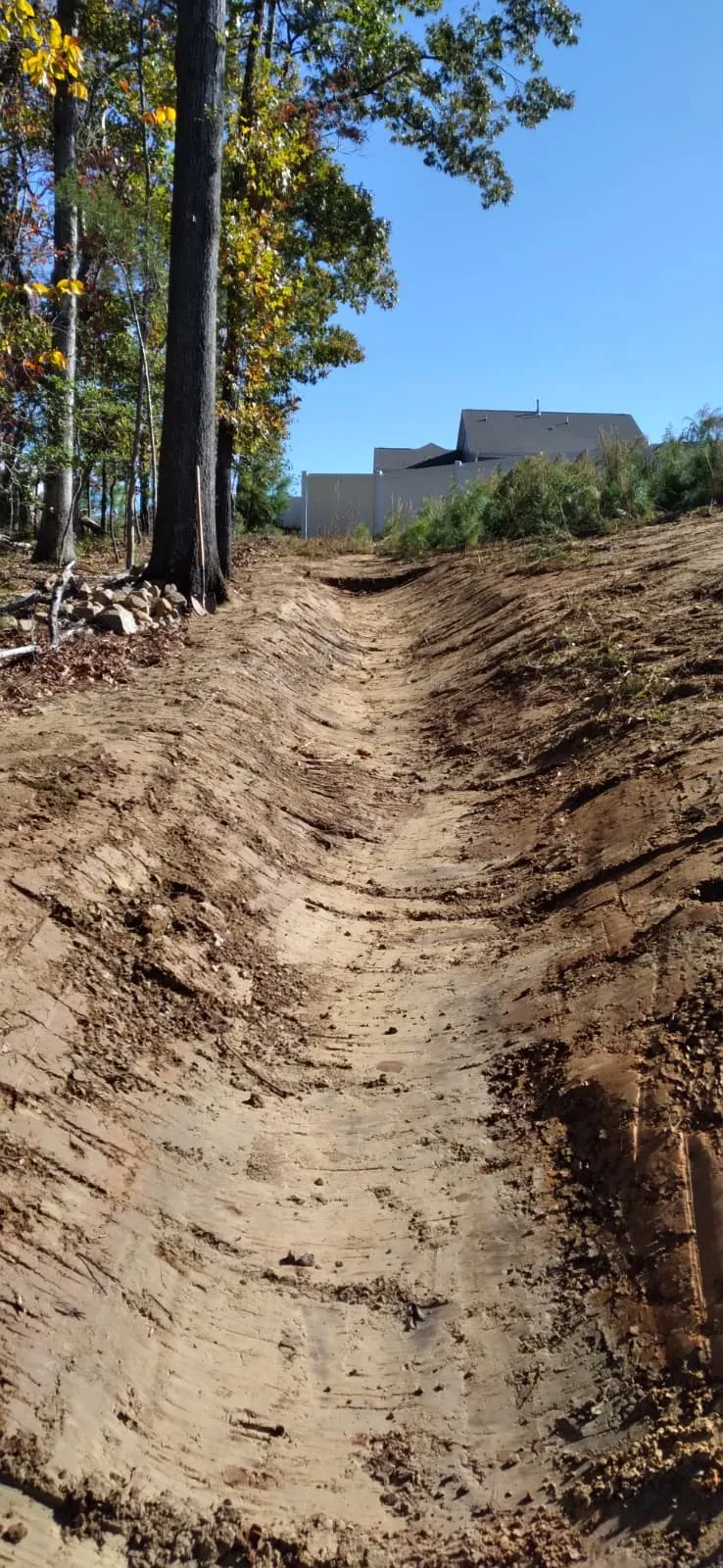 Drainage channel dug into a slope before stabilization at Autumnwood
