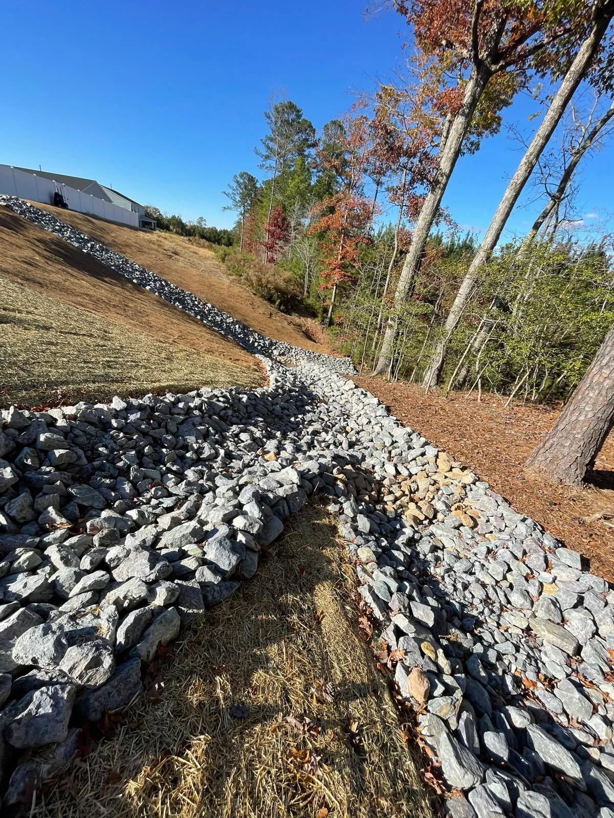 Erosion control matting along a graded path at Autumnwood