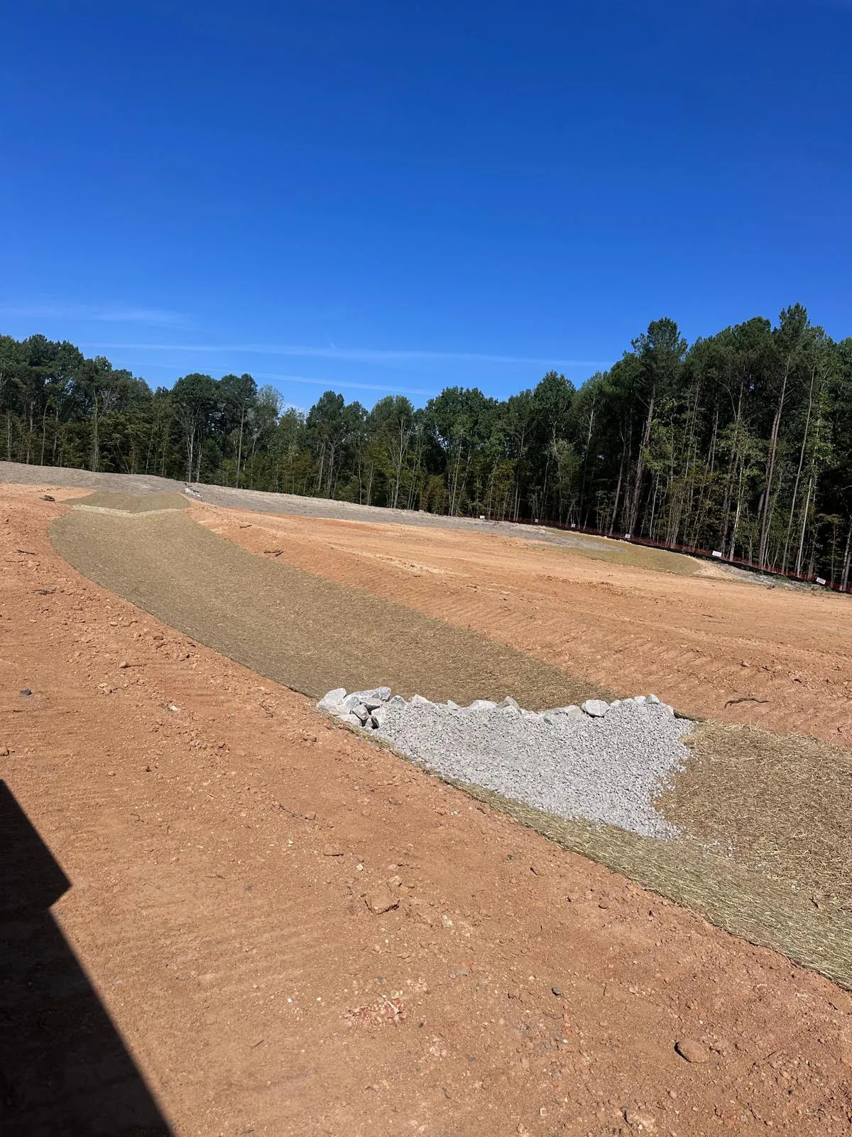 Check dam slowing flow in a stormwater channel at Banks Twenty