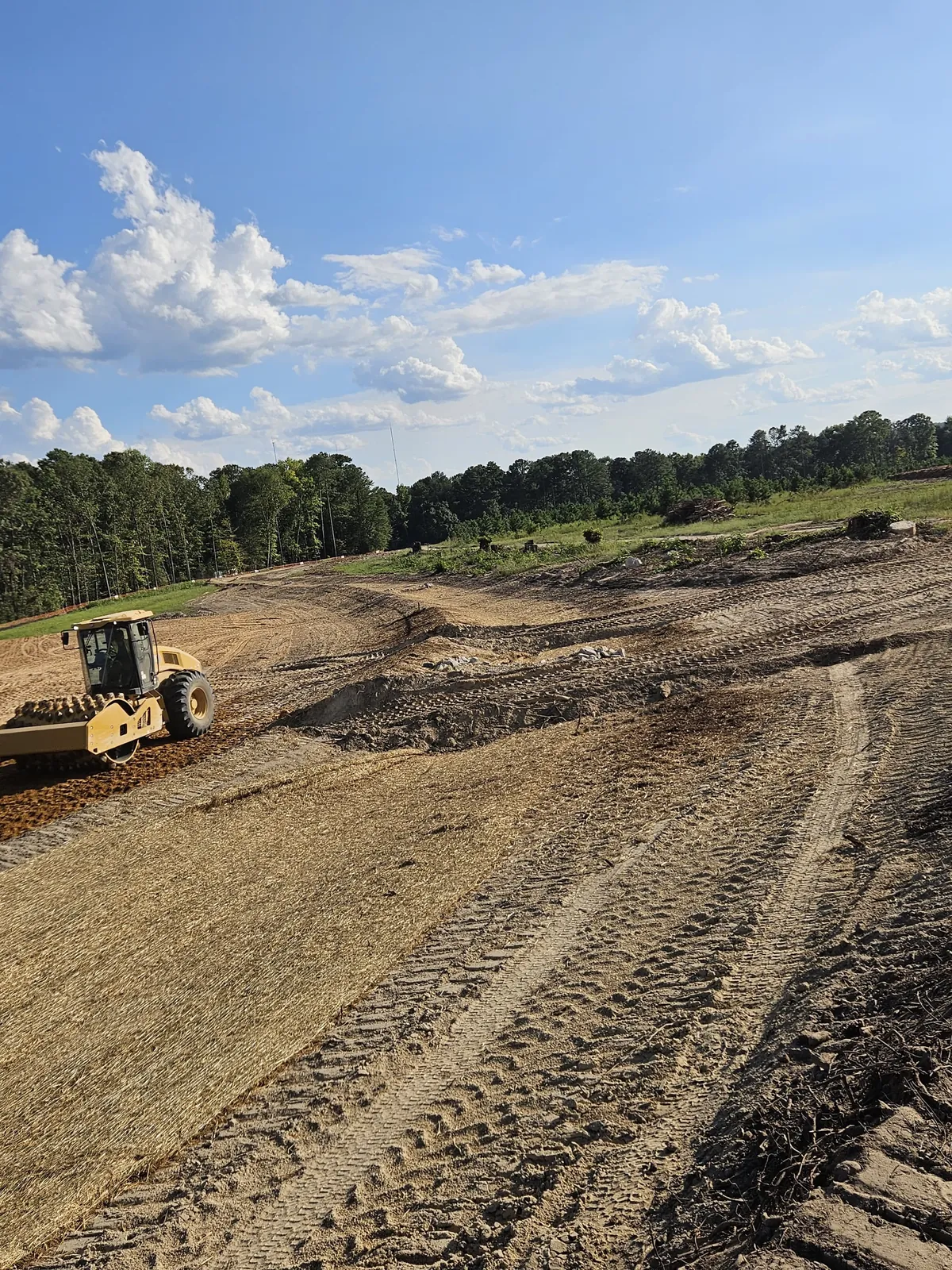 Roller compactor grading a basin slope at Banks Twenty