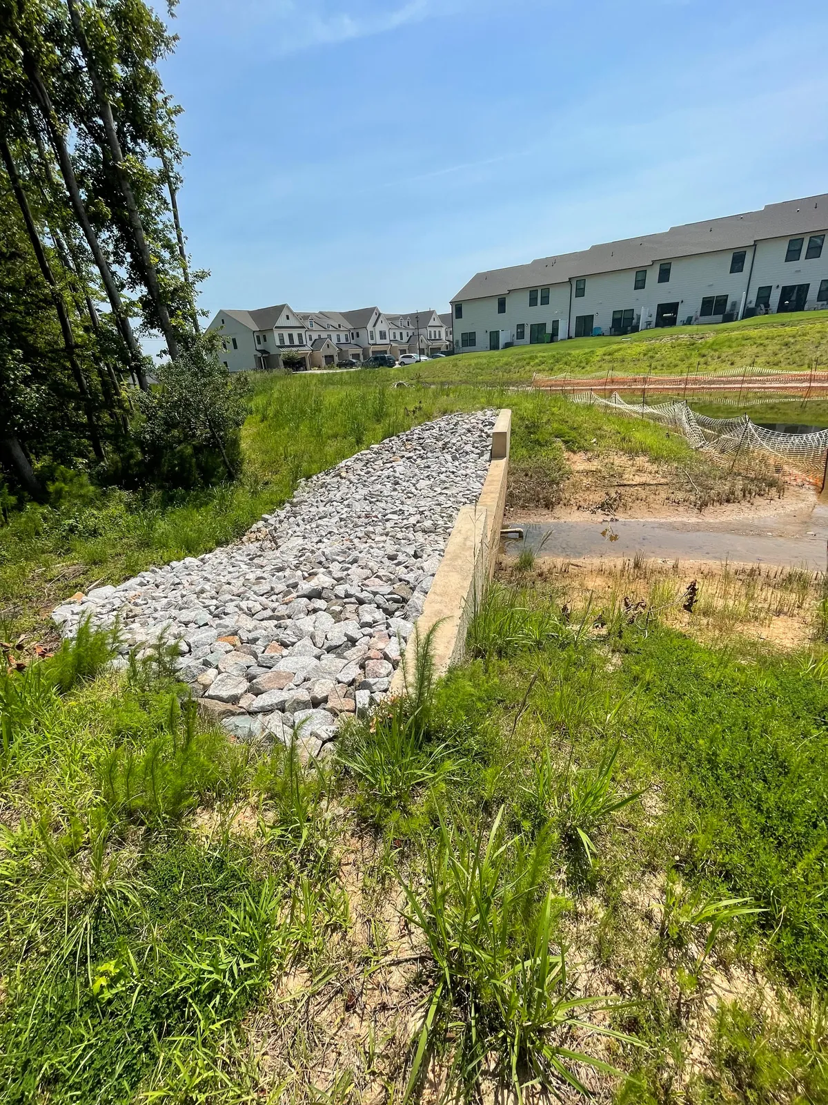 Concrete weir outlet discharging into a stormwater pond