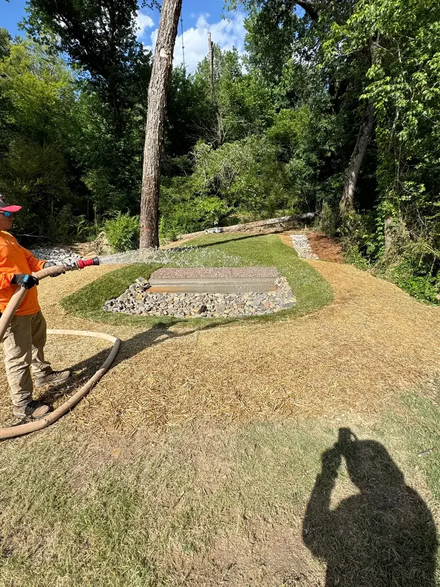 Finished rip-rap stone dissipator pad with lawn established after Delcid's work