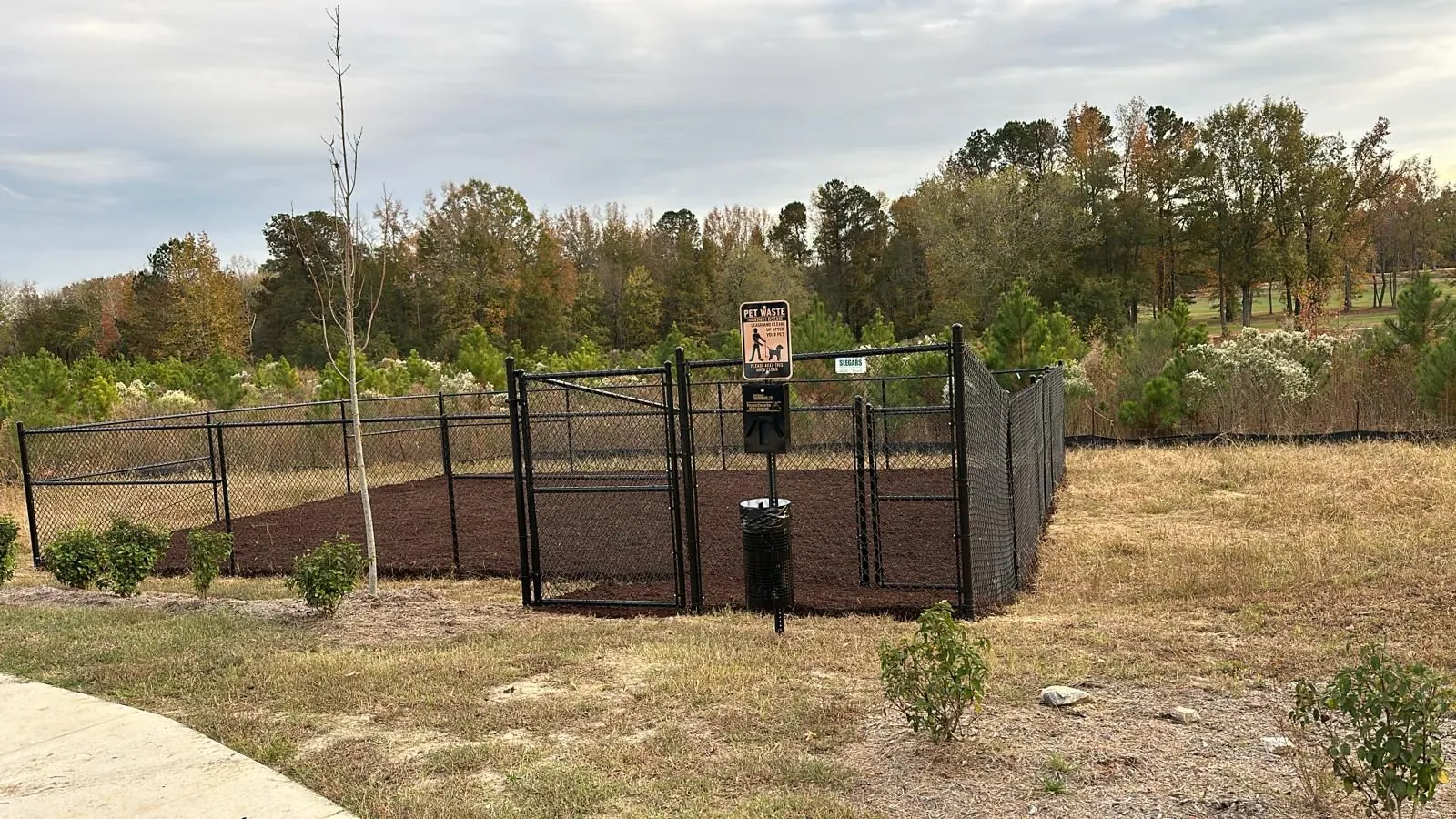 Freshly mulched planting bed at a community entrance, Parc Townes at Wendell