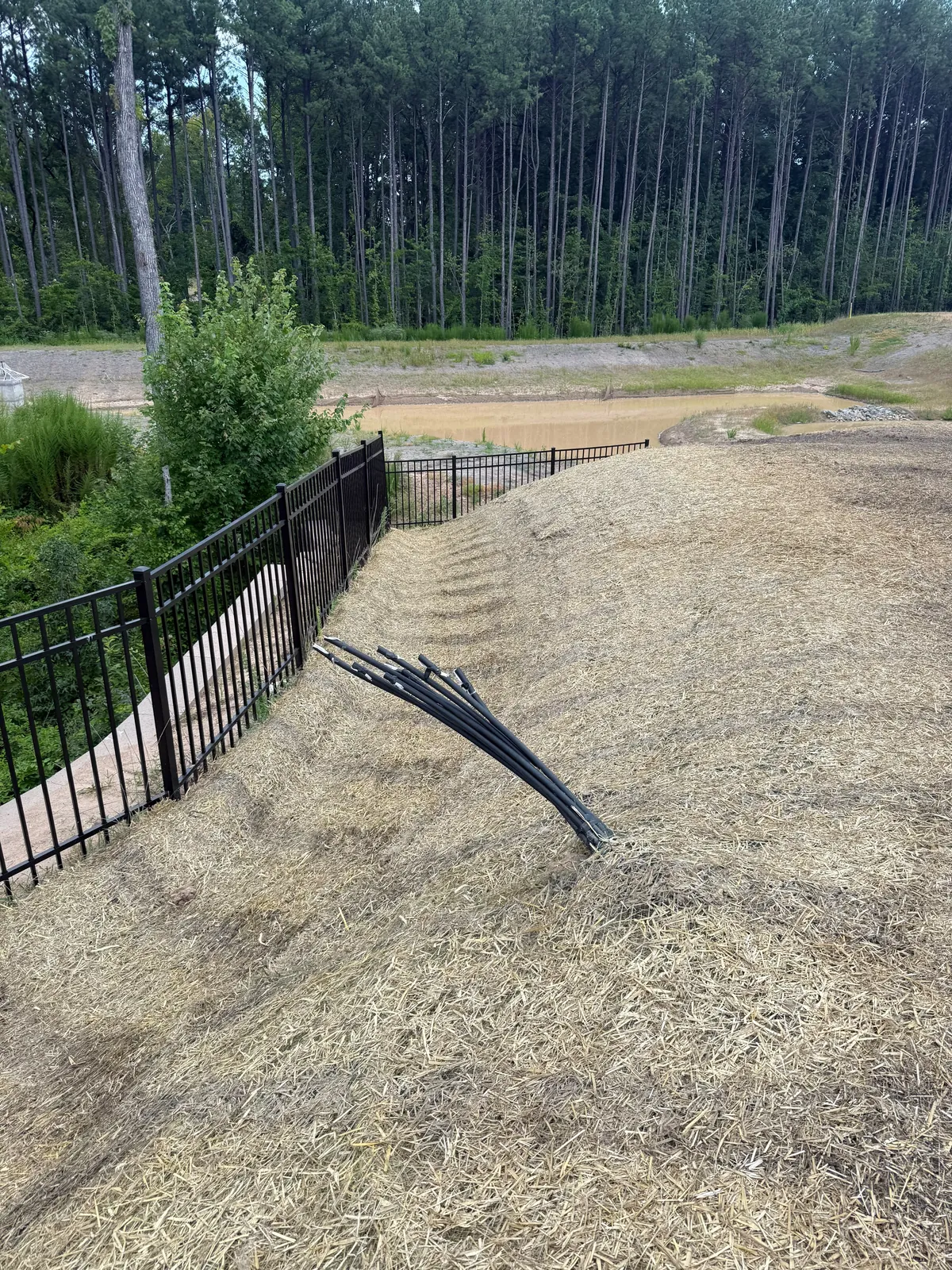 Silt fence installation on a graded slope at Mica Ridge