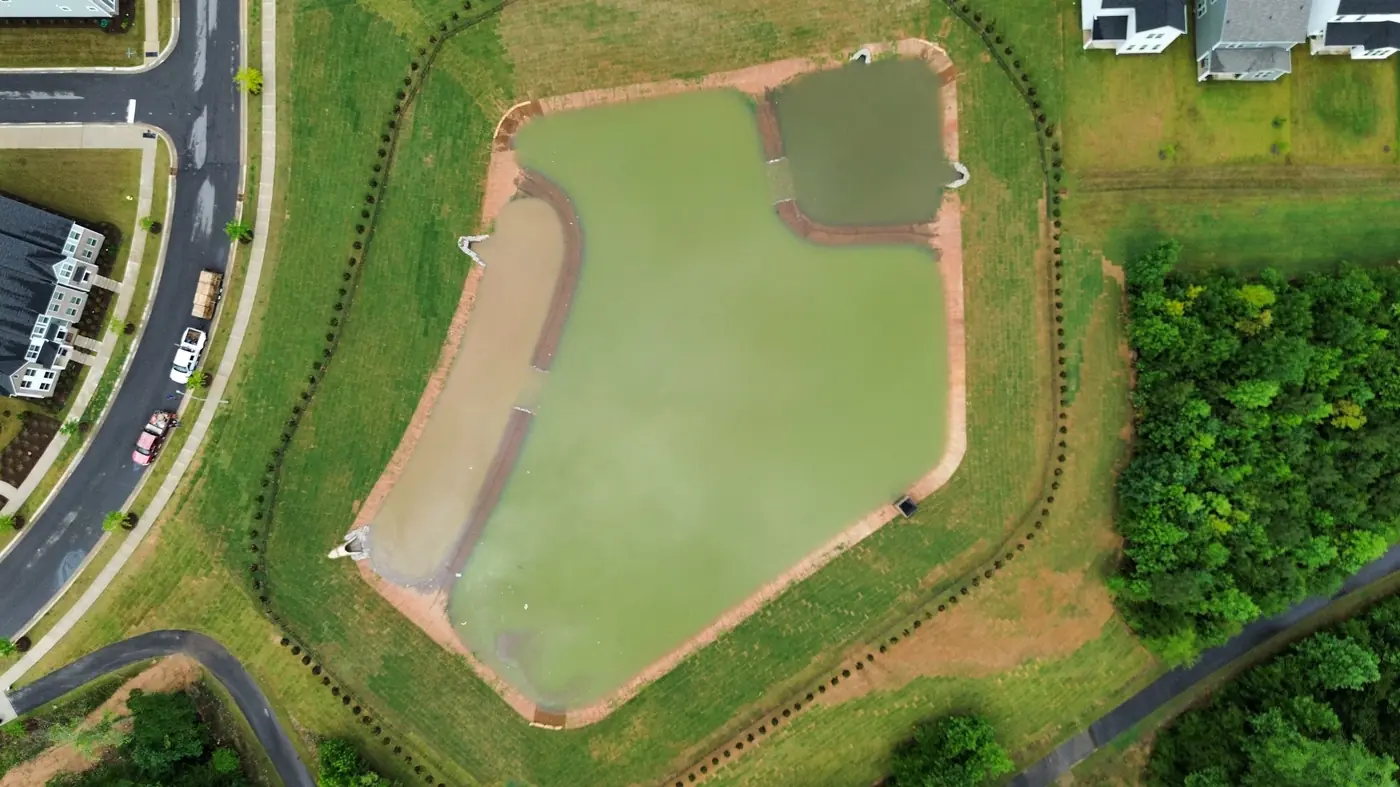 Aerial view of a completed stormwater pond system after Delcid's work