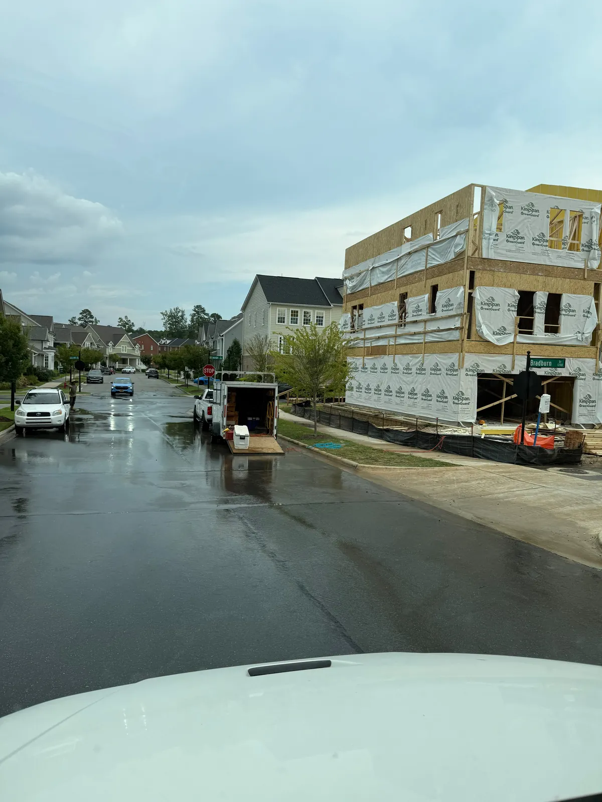 Equipment trailer parked on a freshly washed street
