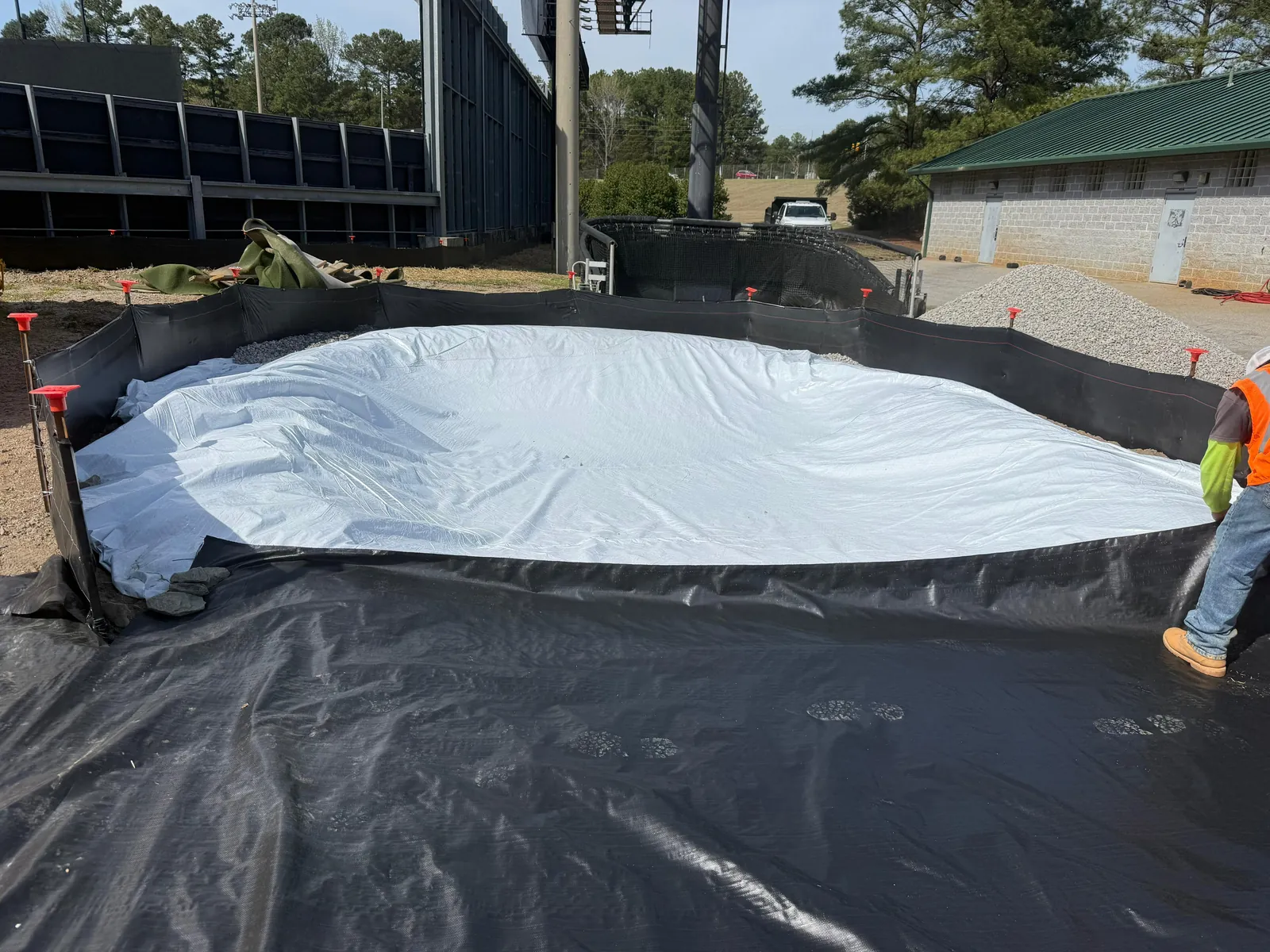 Crew installing a lined concrete washout pit