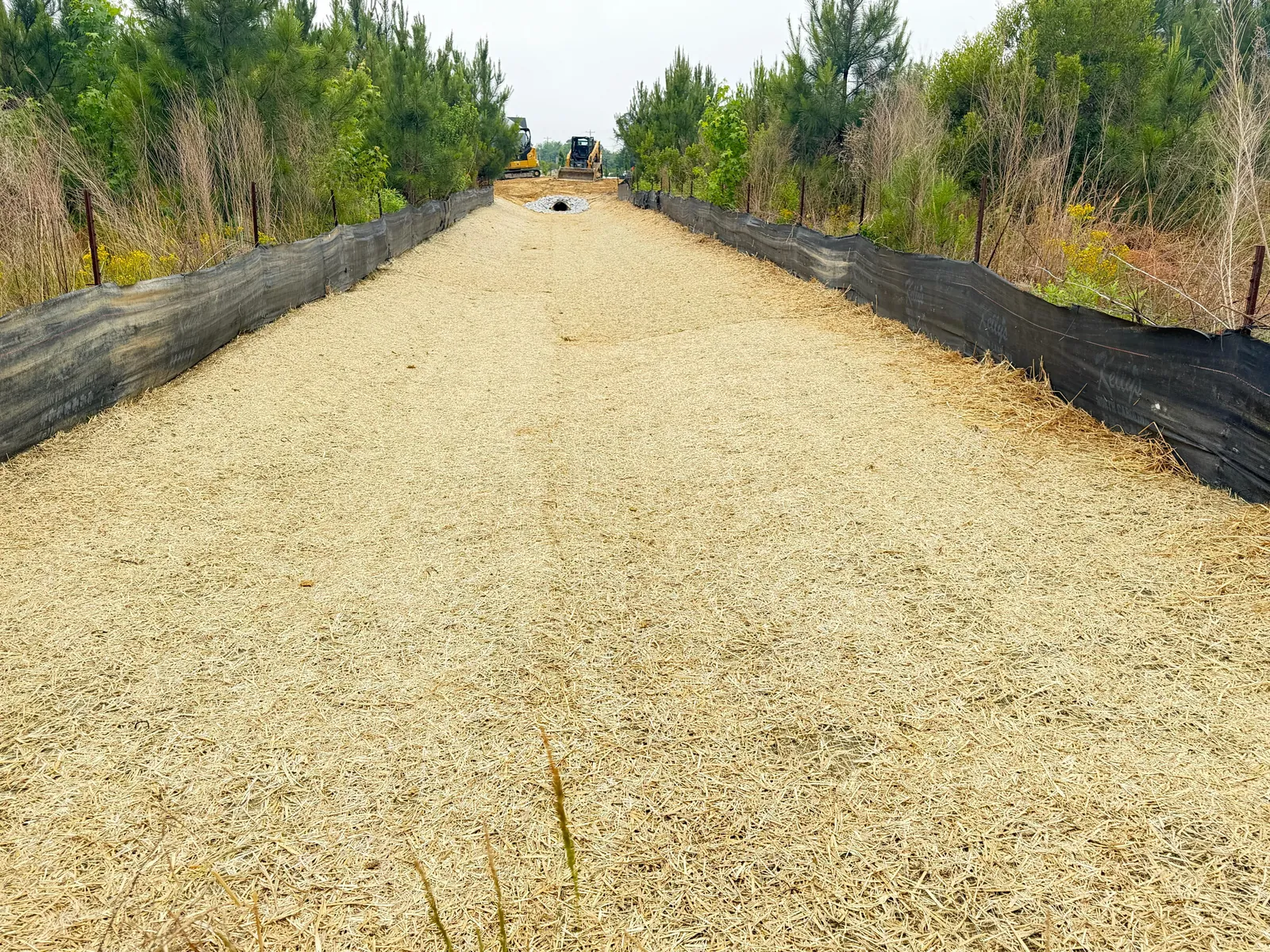 Erosion control matting along a channel at Wendell Falls Pond